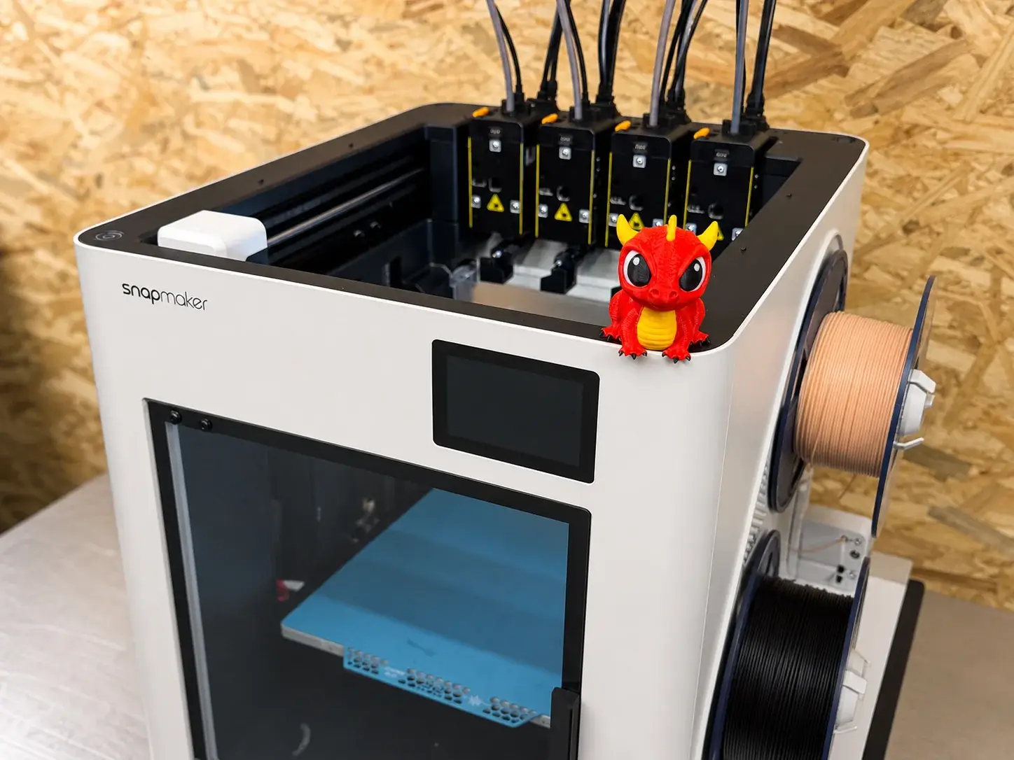 Snapmaker multi-tool printer beside a small red dragon print