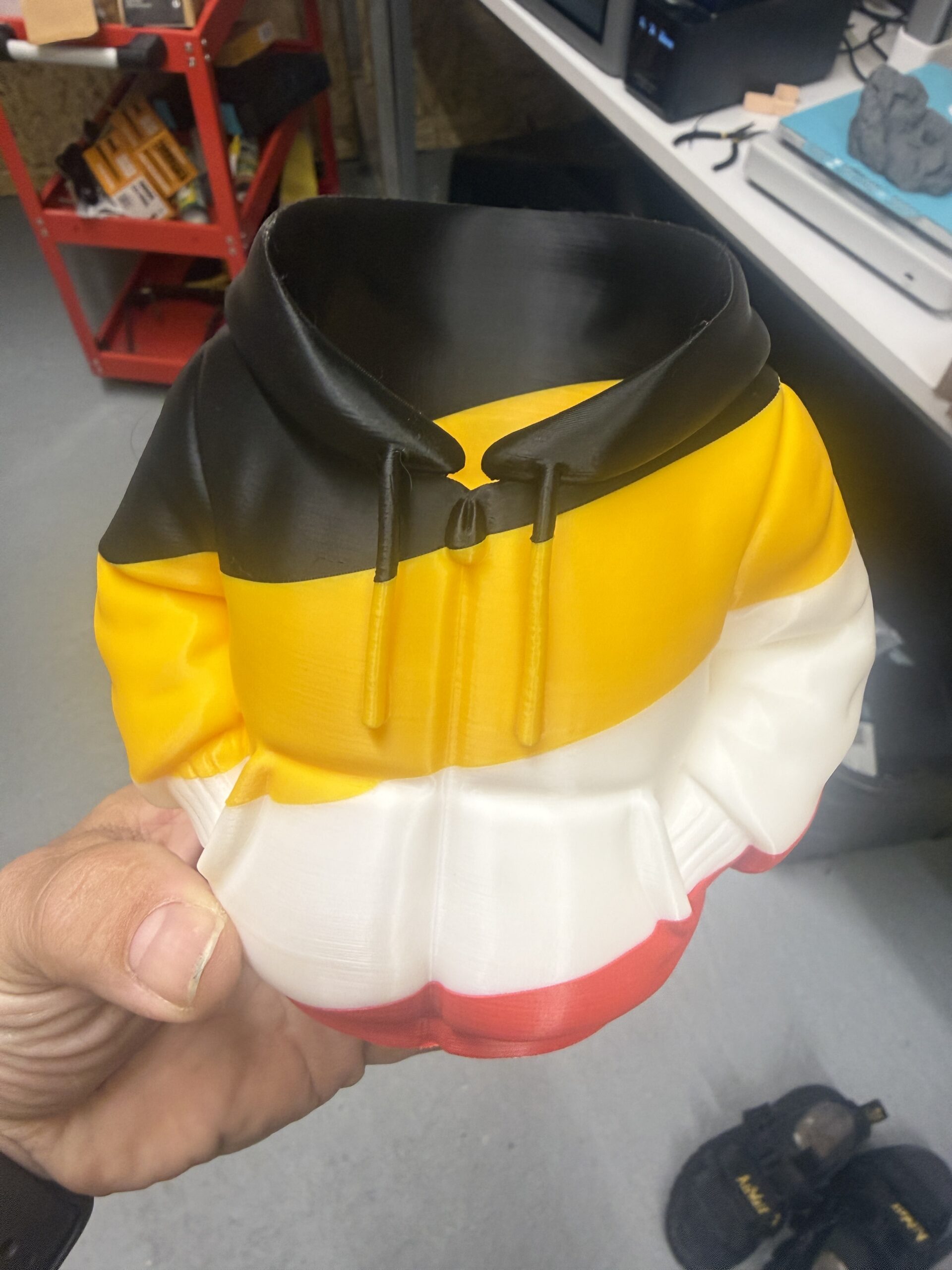 A finished multi-colour print held in the Layer3D workshop