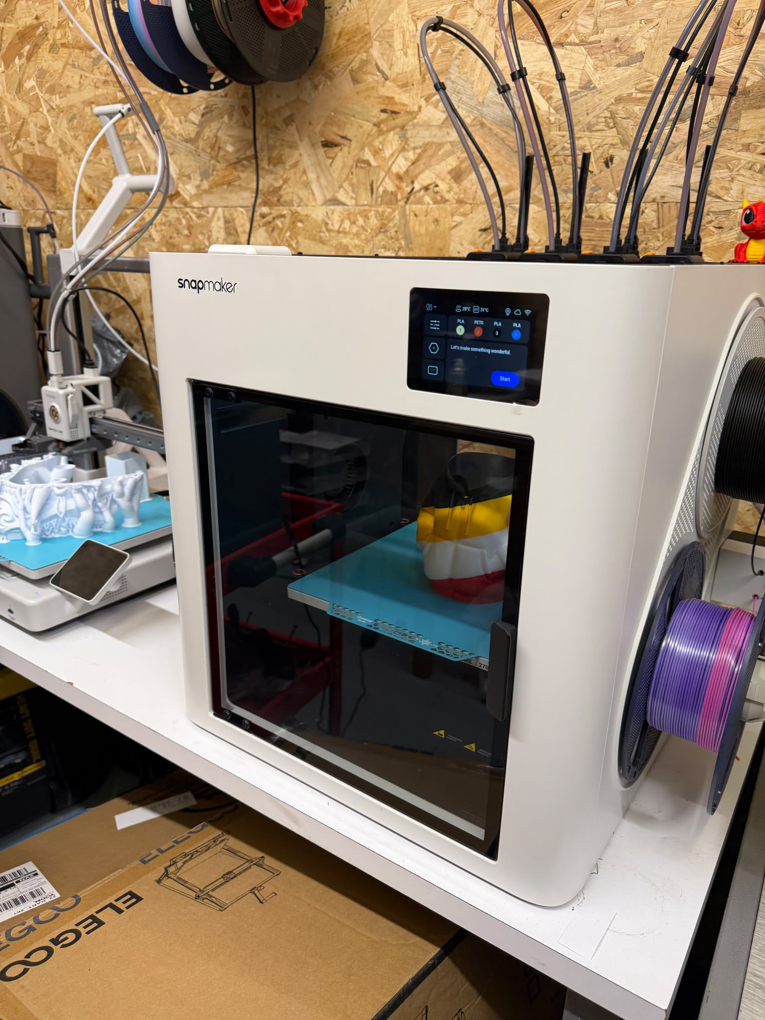 Snapmaker multi-tool printer on the showroom workbench